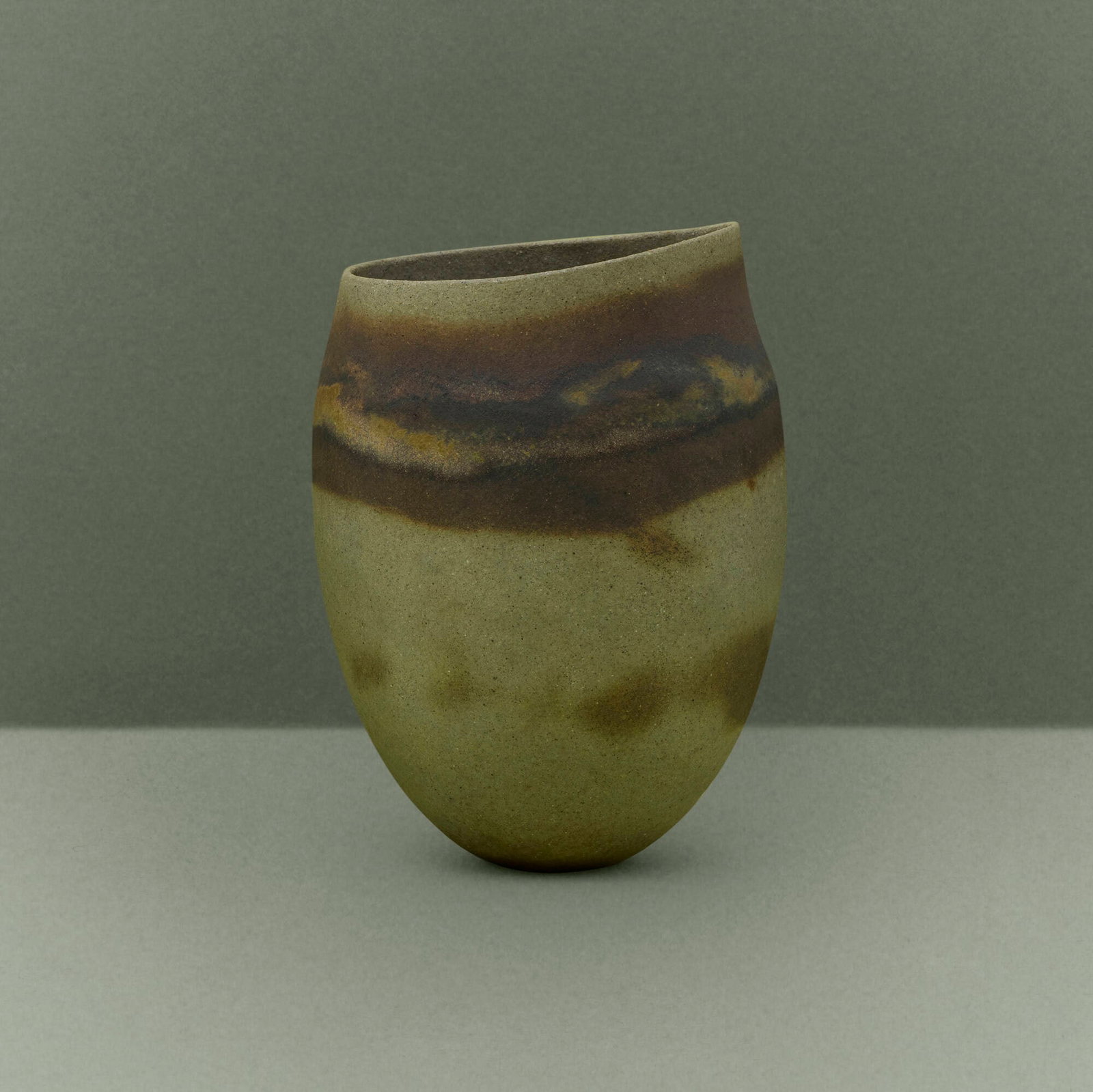 Jennifer Lee, Olive asymmetric pot, dark halos: Jennifer Lee Olive asymmetric pot, dark halos 1985 hand-built colored stoneware with oxides 5.75 h x 4.25 dia in (15 x 11 cm) This work is registered in the artist's records as JL-401/107.