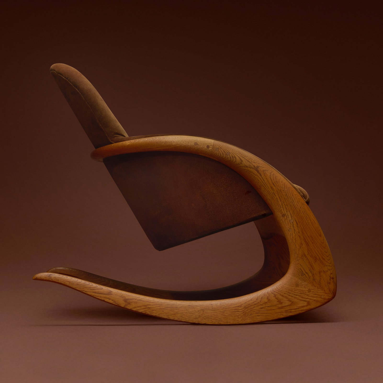 Wendell Castle, Crescent rocker: Wendell Castle Crescent rocker USA, 1974 oak, suede upholstery 33 h x 25 w x 36 d in (84 x 63 x 91 cm) Carved signature and date to interior of one leg 'WC 74'. This work is from an o