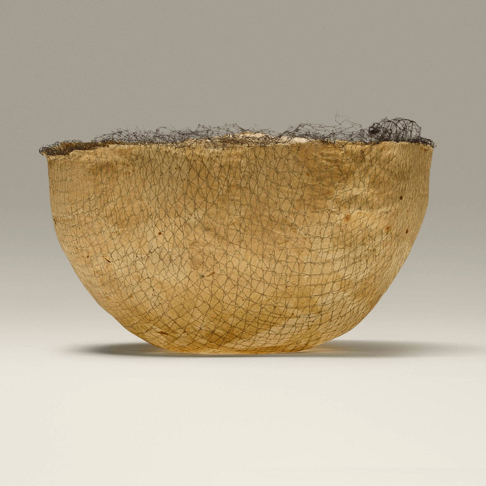 Kay Sekimachi, Bowl: Kay Sekimachi Bowl mulberry paper, netting 3.5 h x 7 dia in (9 x 18 cm) Artist's mark to underside. Provenance: Collection of Jack Lenor Larsen This work will ship from Lambertville, New Jersey.