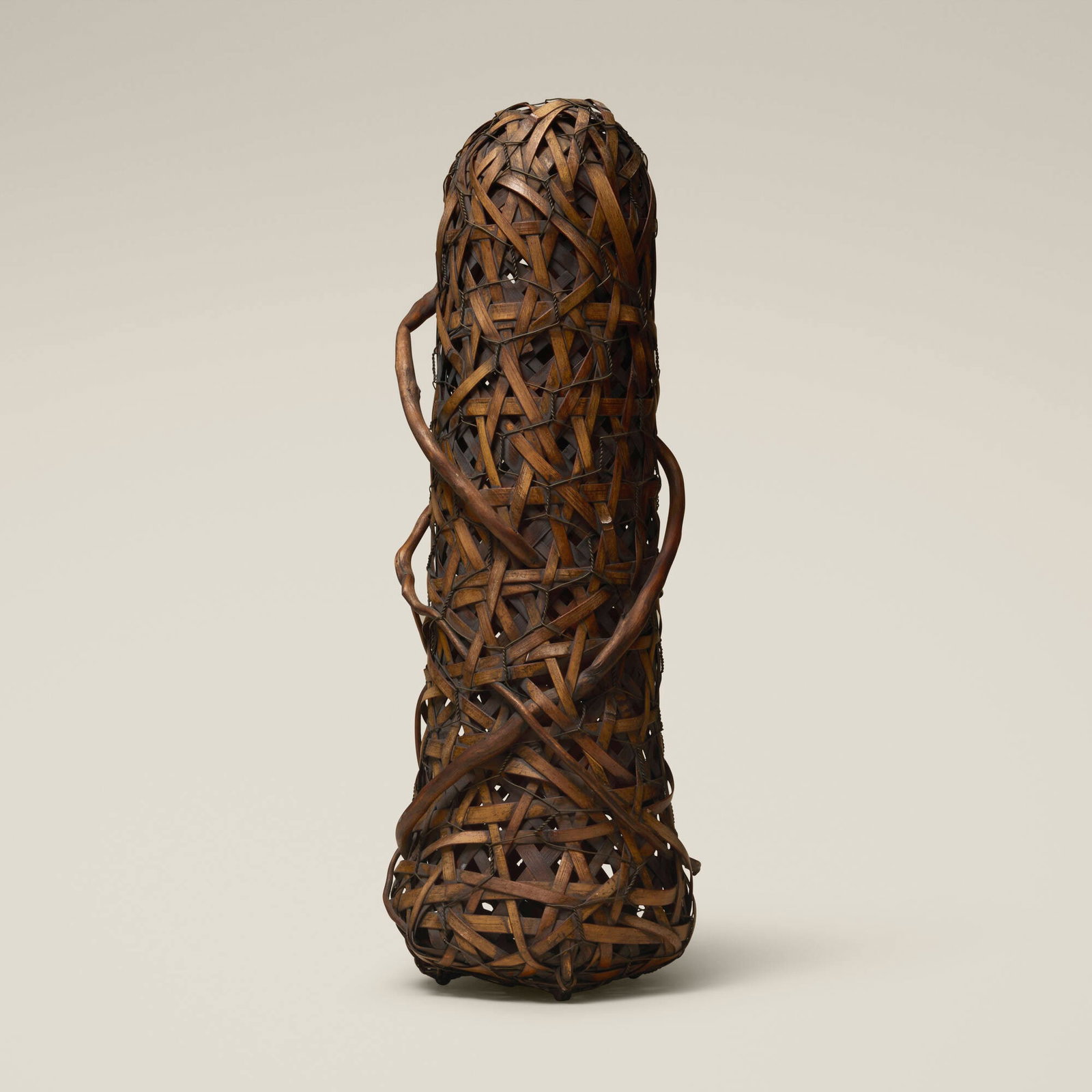 Jiro Yonezawa, Cocoon 11: Jiro Yonezawa Cocoon 11 woven bamboo, cedar root, chicken wire 18.5 h x 6.5 dia in (47 x 17 cm) Incised artist's cipher to underside. Provenance: Collection of Jack Lenor Larsen This work will