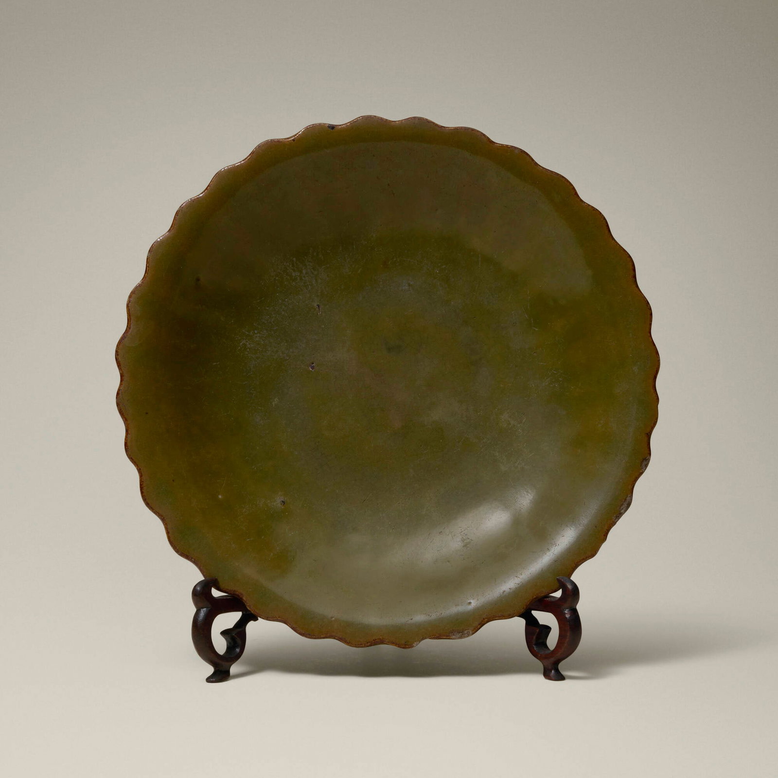 Chinese, Chrysanthemum form dish: Chinese Chrysanthemum form dish first half of the 20th century teadust-glazed stoneware, wood 1.75 h x 8 dia in (4 x 20 cm) Provenance: Collection of Jack Lenor Larsen This work will ship from