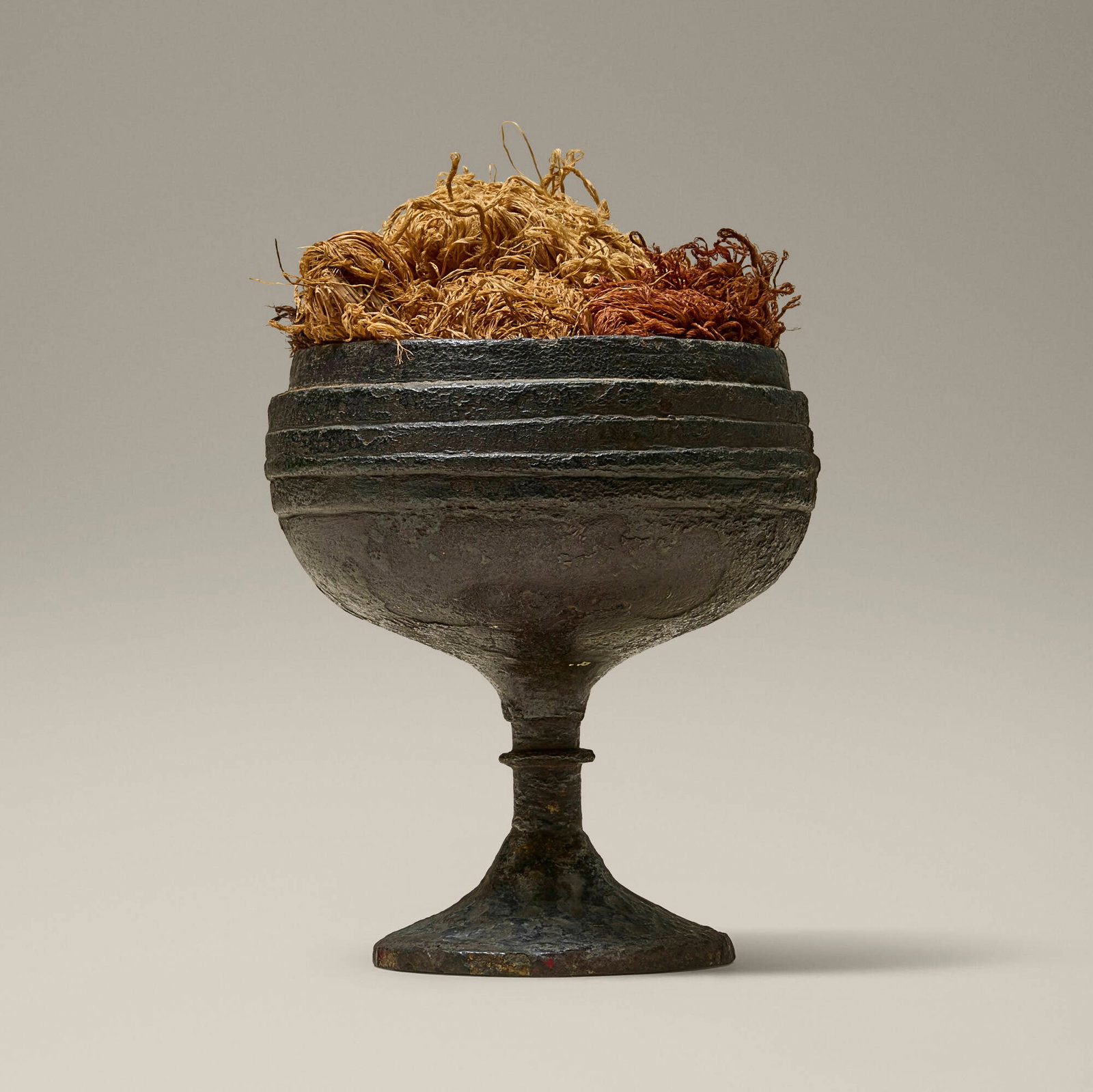 Chinese, Ritual lamp stand: Chinese Ritual lamp stand probably Han Dynasty bronze 7 h x 4.5 dia in (18 x 11 cm) Work features an associated dyed fiber arrangement. Provenance: Collection of Jack Le
