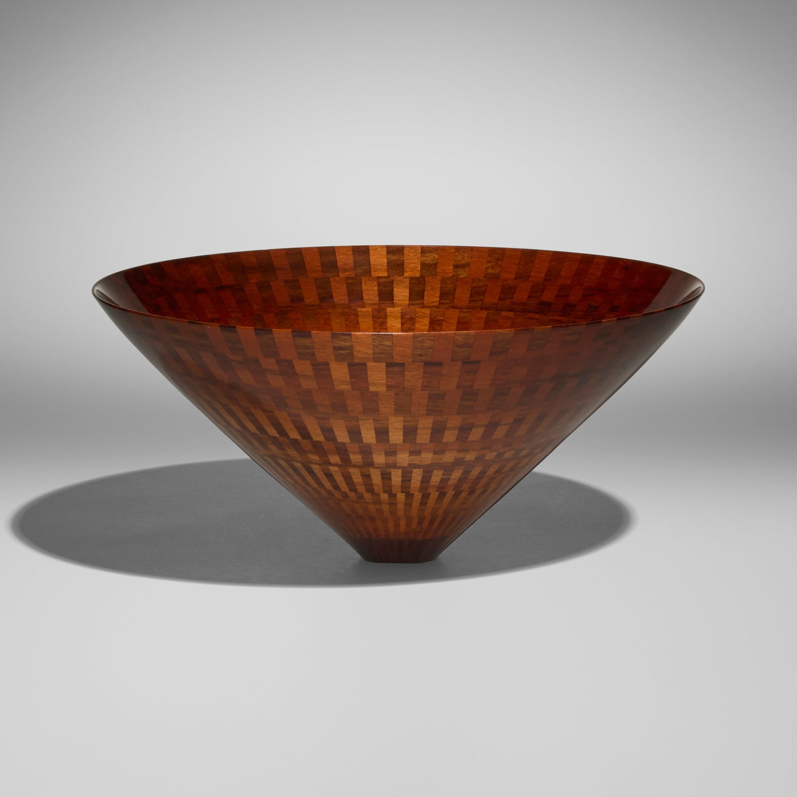 Mike Shuler, Segmented flaring bowl: Mike Shuler Segmented flaring bowl 1998 walnut 5.5 h x 12 dia in (14 x 30 cm) Incised signature, date and number to underside 'Mike Shuler 1998 #871'. Provenance: Barry Friedman Gallery,