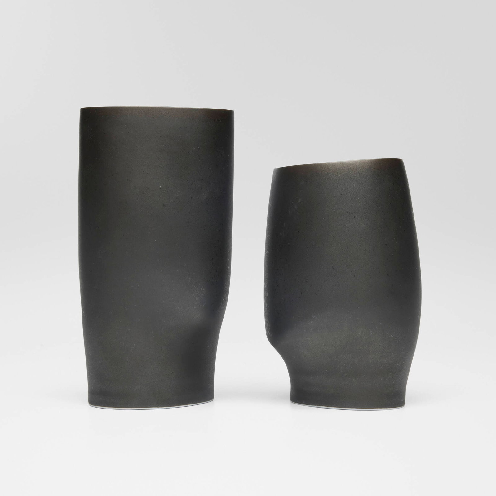 Sara Flynn, Vases, set of two: Sara Flynn Vases, set of two c. 2010 glazed porcelain 7.25 h x 3.75 w x 3.375 d in (18 x 10 x 9 cm) 5.875 h x 4 w x 3.75 d in (15 x 10 x 10 cm) Impressed chop mark to underside of each example
