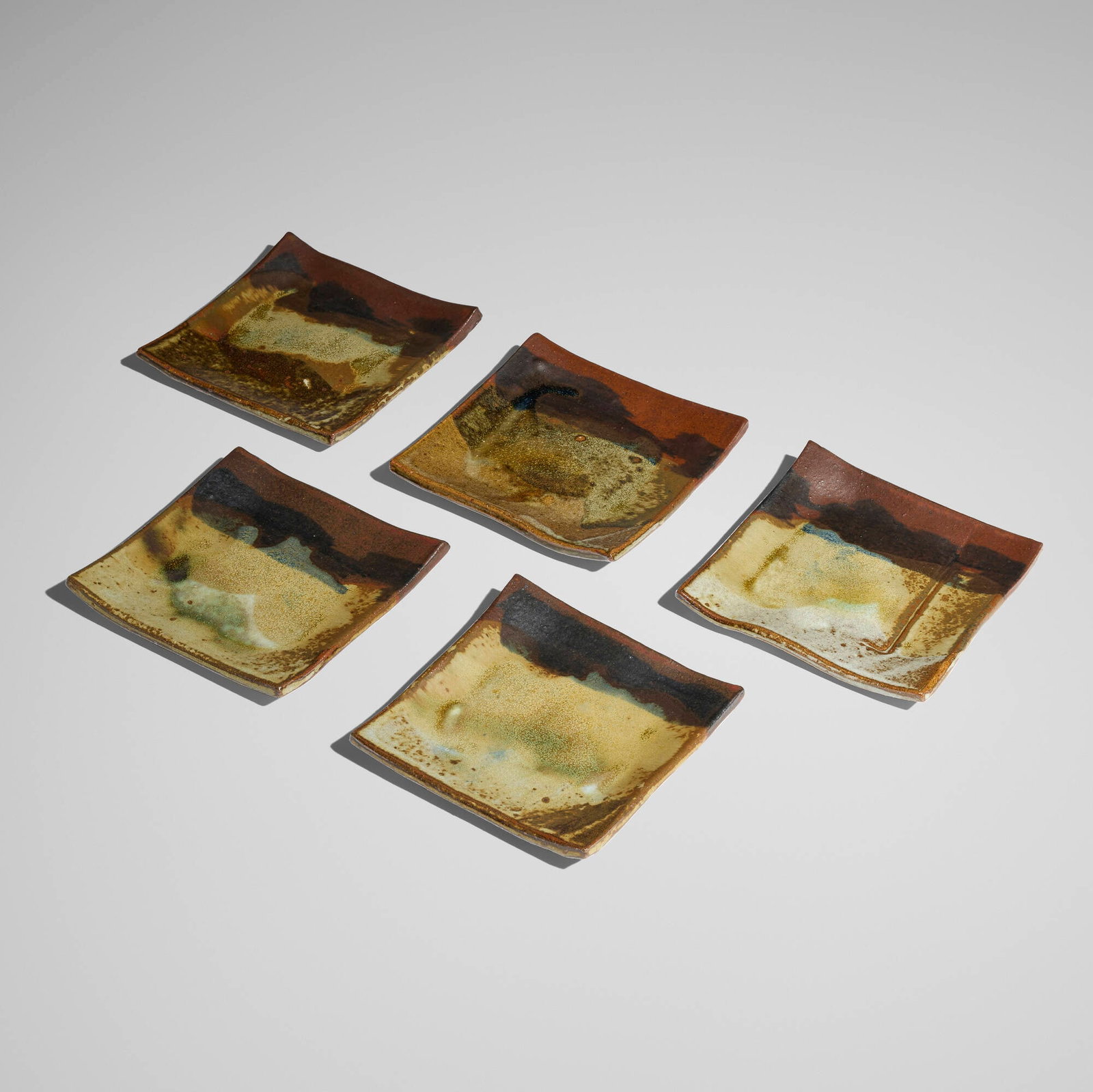 Toshiko Takaezu, Collection of five plates: Toshiko Takaezu Collection of five plates c. 1980 glazed stoneware 1 h x 6 w x 6 d in (3 x 15 x 15 cm) Incised signature to underside of each example 'TT'. Provenance: Private Collection, California
