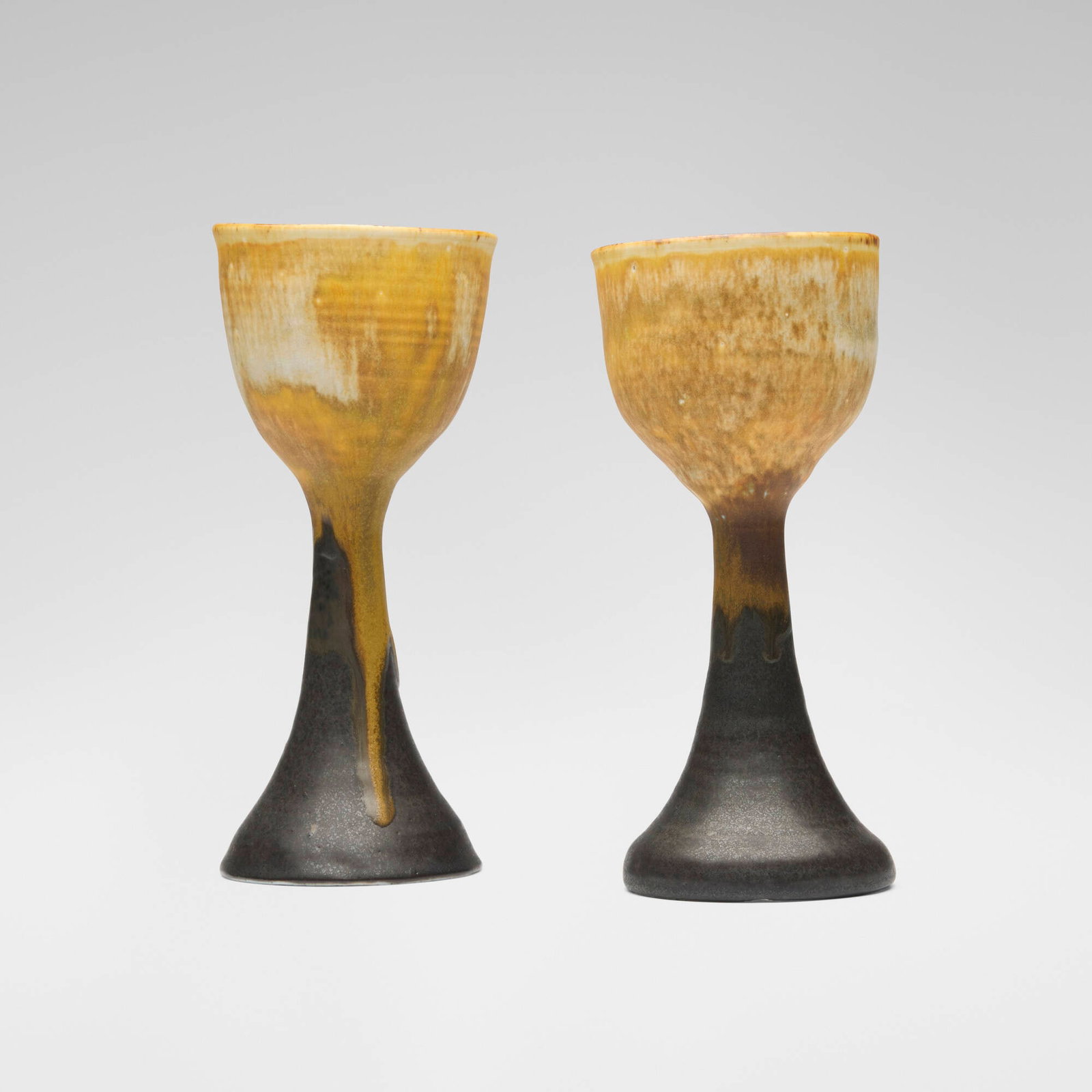 Toshiko Takaezu, Goblets (two works) (with rattle): Toshiko Takaezu Goblets (two works) (with rattle) c. 1985 glazed porcelain 8.5 h x 3.625 dia in (22 x 9 cm) 8.25 h x 3.625 dia in (21 x 9 cm) Incised signature to underside of one example 'TT'.