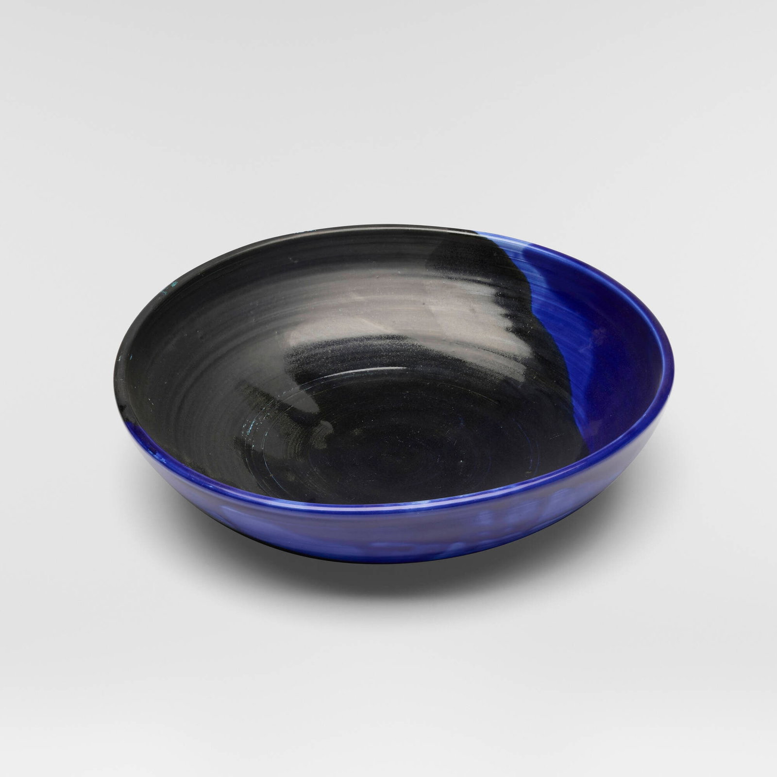 Toshiko Takaezu, Bowl: Toshiko Takaezu Bowl c. 1997 Glass Blue-glazed porcelain 3.125 h x 12.25 dia in (8 x 31 cm) Incised signature to underside 'TT'. Provenance: Acquired directly from the artist, Collection of