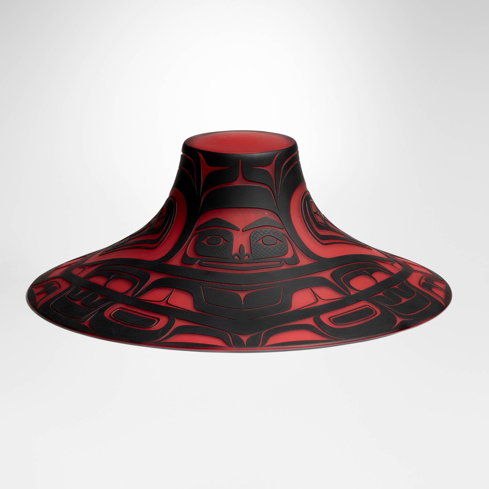 Preston Singletary, Tlingit Crest Hat: Preston Singletary Tlingit Crest Hat 2004 hand-blown and sand-carved glass 7.625 h x 20.5 w x 20.875 d in (19 x 52 x 53 cm) Etched signature and date to edge of interior 'Preston Singletary