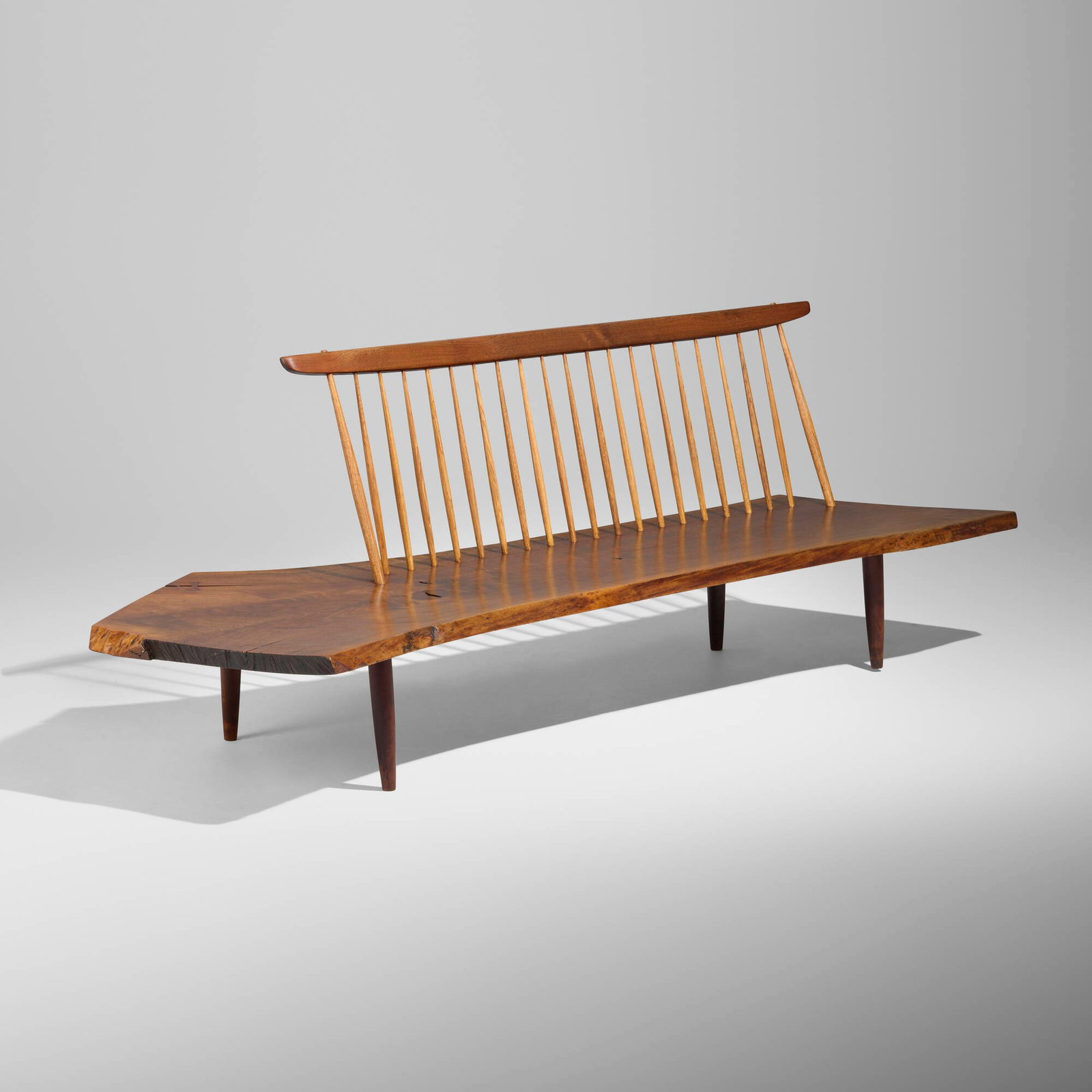 George Nakashima, Exceptional Conoid bench: George Nakashima Exceptional Conoid bench Nakashima Studio USA, 1962 American black walnut, hickory, rosewood 29.5 h x 85 w x 35 d in (75 x 216 x 89 cm) Bench features a dramatic single slab seat