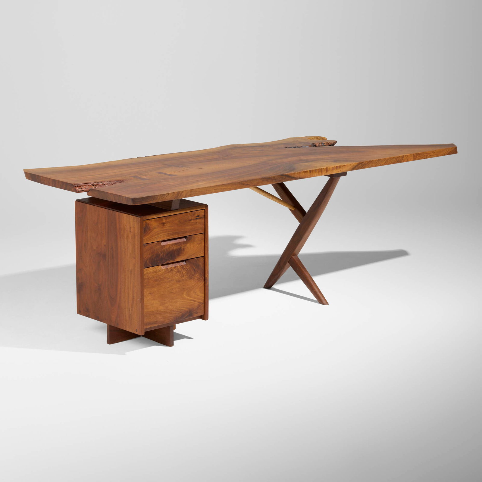 George Nakashima, Exceptional Conoid desk: George Nakashima Exceptional Conoid desk Nakashima Studio USA, 1973 English walnut, American black walnut, hickory, rosewood 29.25 h x 84.75 w x 34.5 d in (74 x 215 x 88 cm) Desk features a dramatic s