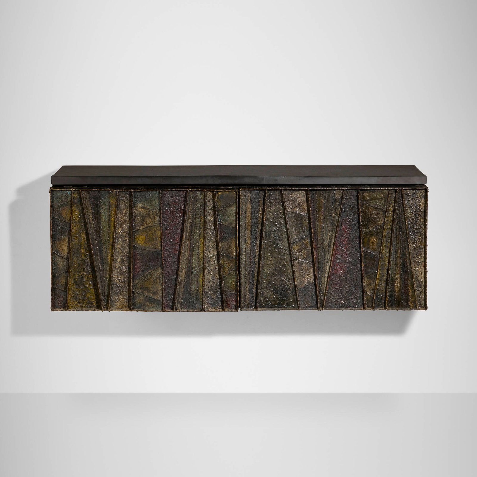Paul Evans, Deep Relief wall-hanging cabinet, model PE 19: Paul Evans Deep Relief wall-hanging cabinet, model PE 19 Paul Evans Studio for Directional USA, c. 1970 torch-cut, welded, polychromed and patinated steel, slate, lacquered wood 17 h x 48.25 w x