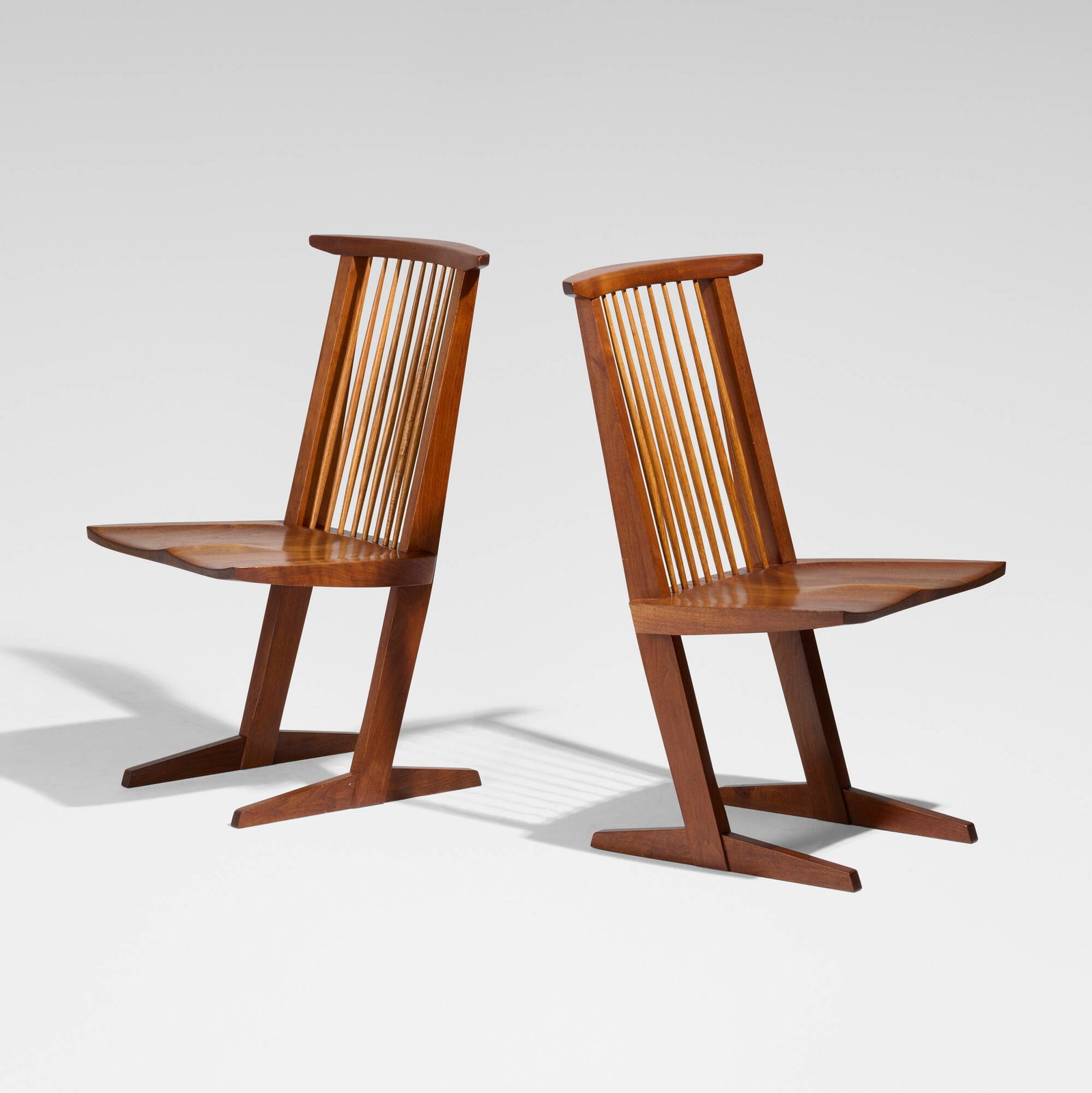 George Nakashima, Conoid chairs, pair: George Nakashima Conoid chairs, pair Nakashima Studio USA, 1966 American black walnut, hickory 35.25 h x 20 w x 22.5 d in (90 x 51 x 57 cm) Inscribed with client's name to underside of each