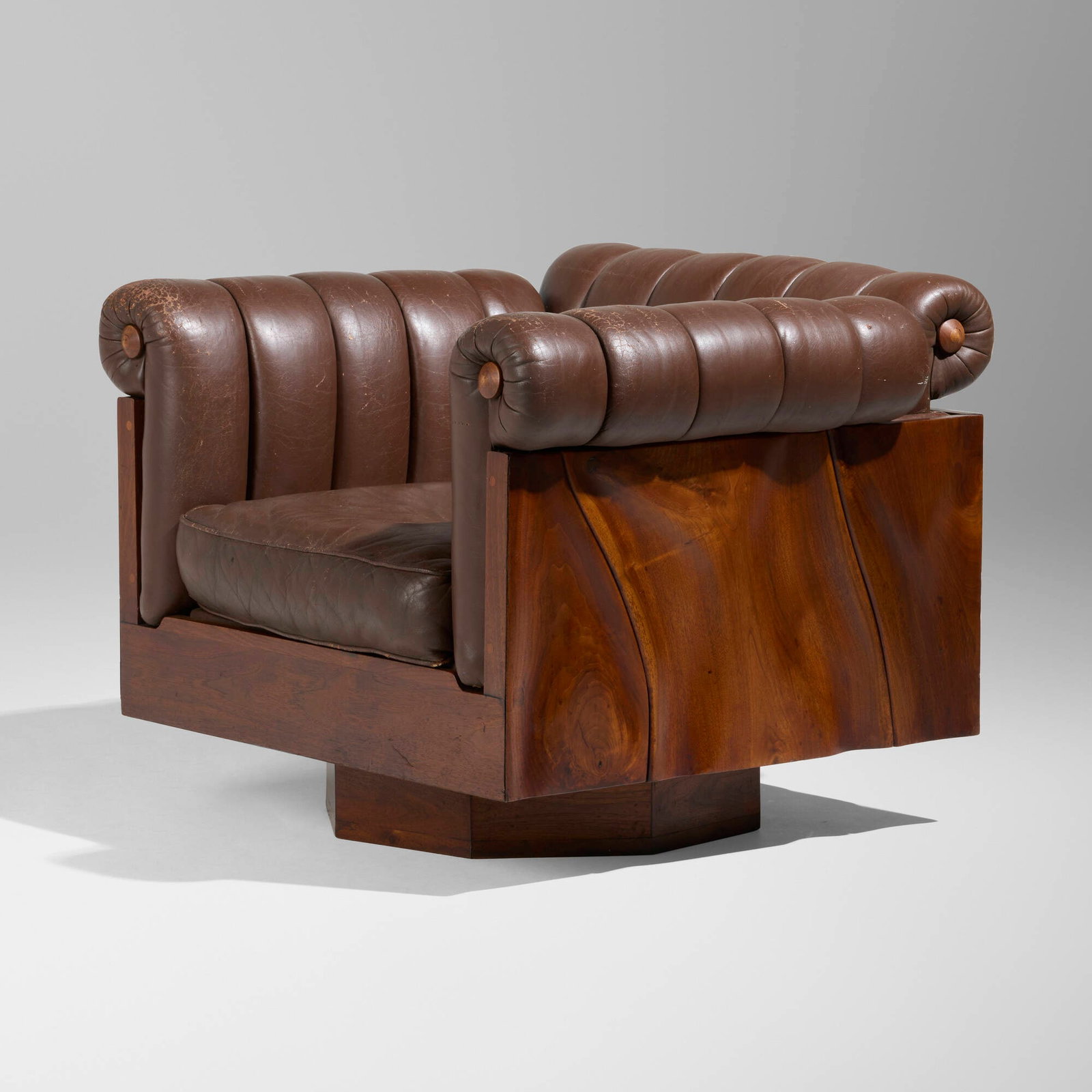 Phillip Lloyd Powell, Rare swivel lounge chair: Phillip Lloyd Powell Rare swivel lounge chair USA, c. 1970 sculpted walnut, leather upholstery 26 h x 34.5 w x 31 d in (66 x 88 x 79 cm) Paper upholsterer's label to underside of seat cushion