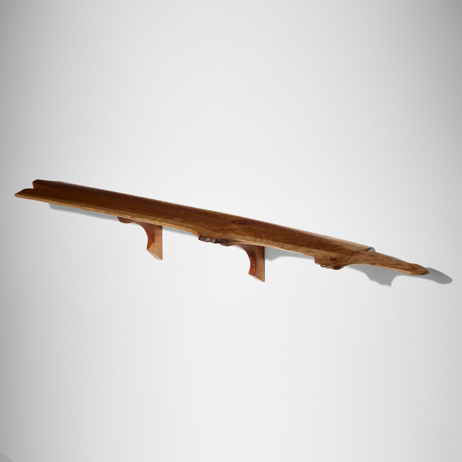 Phillip Lloyd Powell, Wall-hanging shelf: Phillip Lloyd Powell Wall-hanging shelf USA, c. 1975 cherry 11 h x 92 w x 13.75 d in (28 x 234 x 35 cm) Signed to reverse edge 'Phillip Lloyd Powell'. This work will ship from Lambertville,