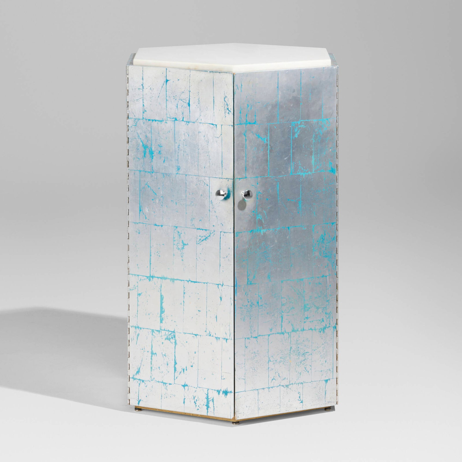 Phillip Lloyd Powell, Hexagonal cabinet: Phillip Lloyd Powell Hexagonal cabinet USA, c. 1975 silver leaf over painted wood, granite, chrome-plated brass 37.5 h x 25.5 w x 22.5 d in (95 x 65 x 57 cm) Cabinet features two doors concealing one