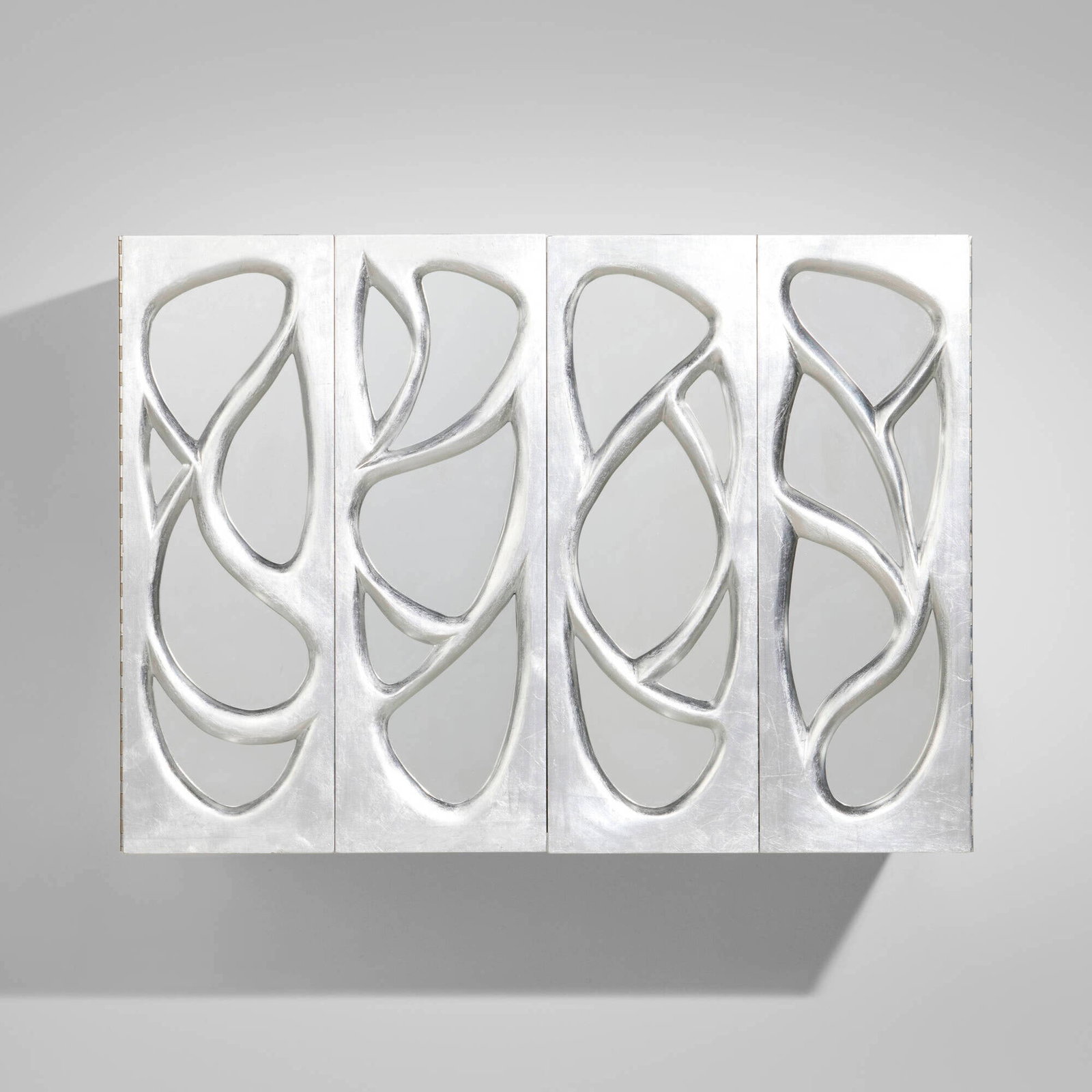 Phillip Lloyd Powell, Wall-mounted cabinet: Phillip Lloyd Powell Wall-mounted cabinet USA, c. 1965 silver leaf over carved wood, mirrored glass 23.5 h x 32.125 w x 24.5 d in (60 x 82 x 62 cm) Cabinet features two bi-fold doors concealing one