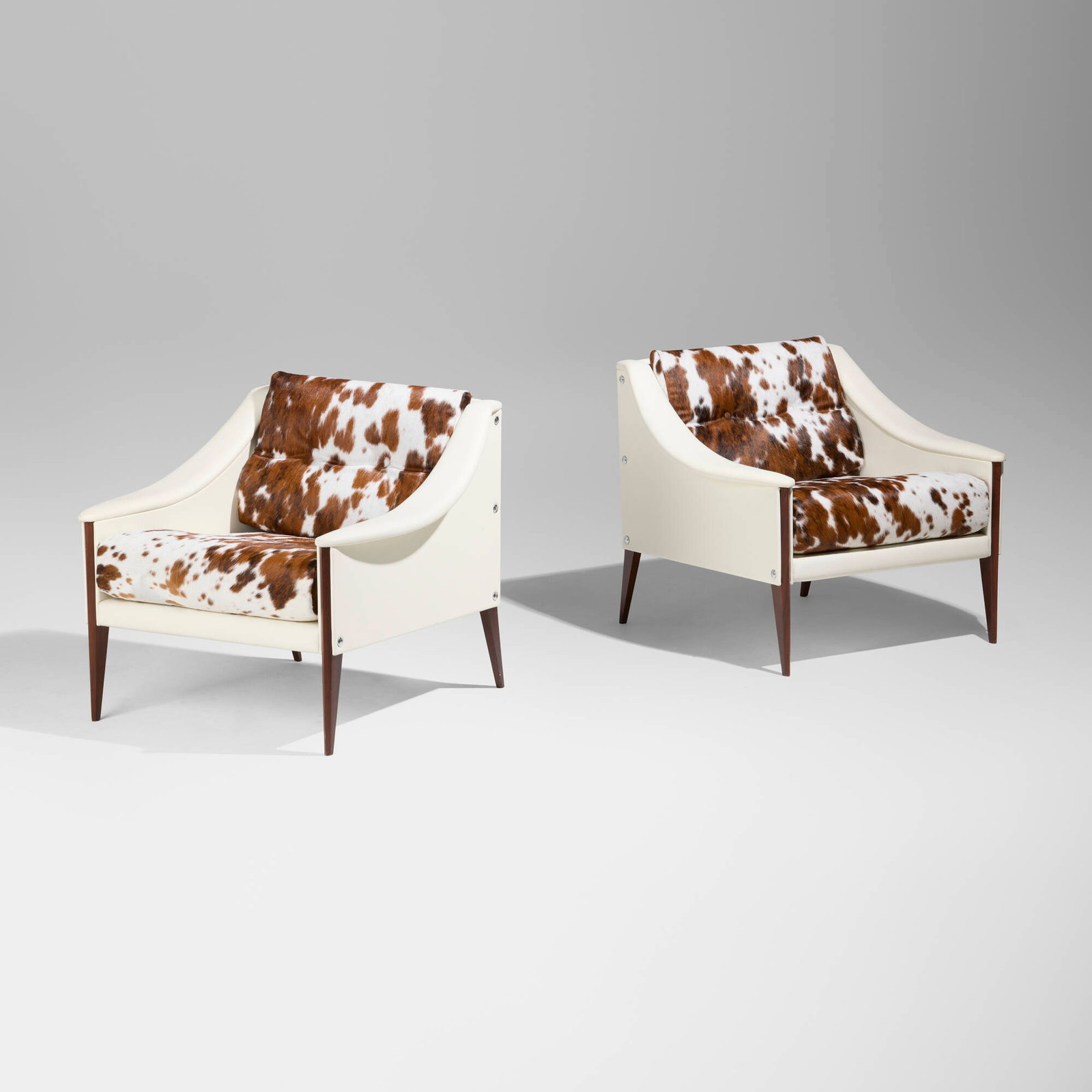Gio Ponti, Dezza 24 armchairs, pair: Gio Ponti Dezza 24 armchairs, pair Poltrona Frau Italy, 1965 / 2022 leather, pony hide, teak, stainless steel 27.5 h x 32 w x 29.25 d in (70 x 81 x 74 cm) Decal manufacturer's label to underside