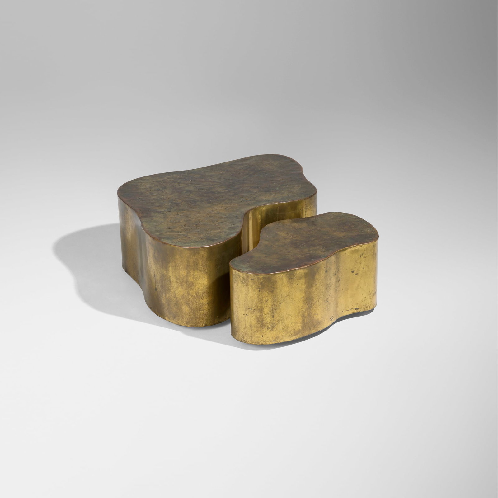 Silas Seandel, Custom Nested Bronze Form coffee tables: Silas Seandel Custom Nested Bronze Form coffee tables USA, c. 1982 brass-plated bronze 15.25 h x 42 w x 38.5 d in (39 x 107 x 98 cm) 13.5 h x 32.5 w x 19 d in (34 x 83 x 48 cm) Incised signature to to