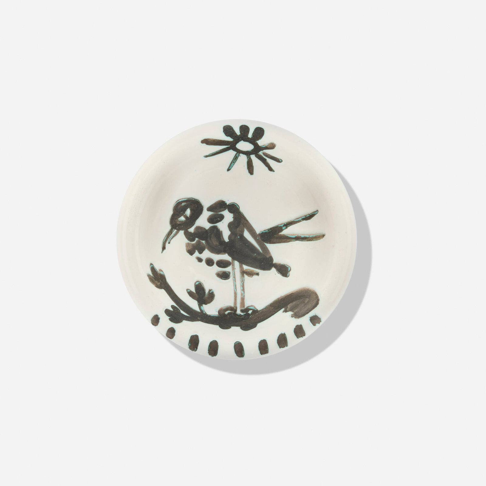 Pablo Picasso, Oiseau au soleil: Pablo Picasso Oiseau au soleil 1952 white earthenware with oxidized paraffin decoration and enamel 1.75 d x 6 dia in (4 x 15 cm) Glazed and impressed studio marks to underside 'Edition Picasso'. Impre