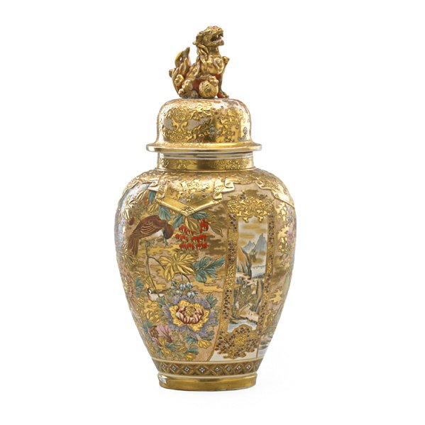 JAPANESE SATSUMA COVERED URN: Heavily decorated with gilt floral and bird decoration, the lid with Buddhist lion finial, early 20th c.; 24"