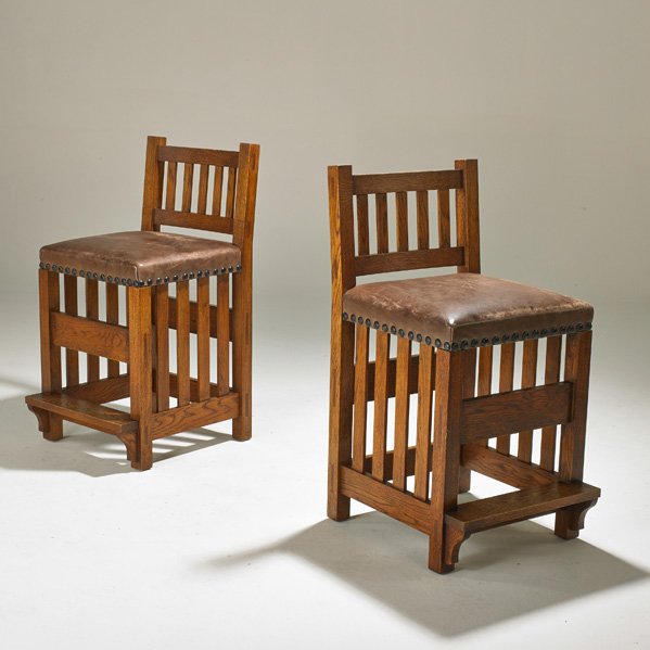 CONTEMPORARY ARTS AND CRAFTS: Pair of bar stools, USA, 1980s; Oak, tacked-on leather seats; Unmarked; 36 1/2" x 18 1/2" x 21 1/2"
