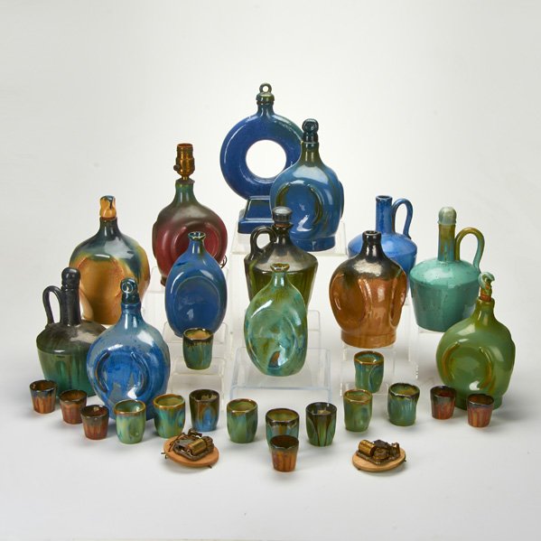 FULPER: Twenty-nine pieces: including ten musical decanters music boxes, sixteen shot glasses, etc., Flemington, NJ, late 1920s; Glazed earthenware; Some marked; Tallest: 12 1/2"