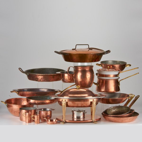 COPPER KITCHENWARE: Twenty-two pieces including Joseph Heinrichs covered chafing dish lined in sterling silver, bain-marie, colander, pitchers, saucepans, etc., early-mid-20th c.; Copper, sterling silver, porcelain, bras