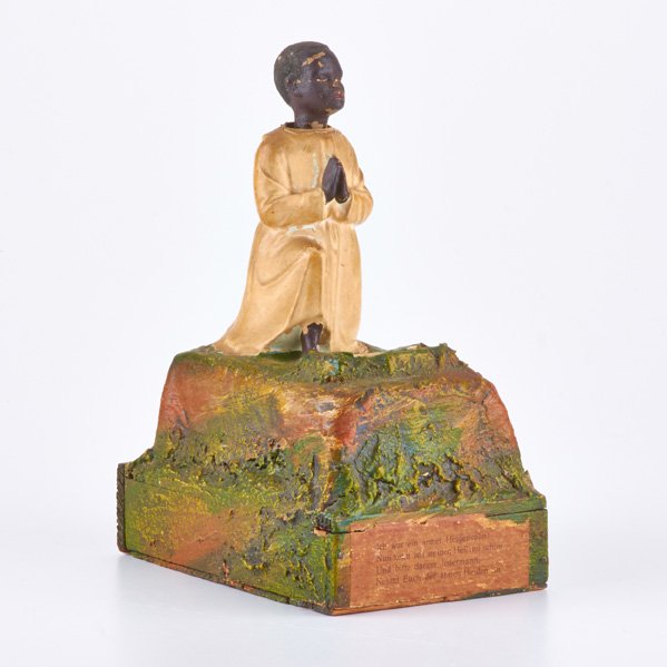 GERMAN: Wooden alms box with bobblehead African boy kneeling in prayer, 19th/20th c.; Paper label: "Ich war ein armer Heidensohn! /Nun kenn ich meinen Heiland schon / Und bitte darum Jedermann. / Nehmt Euch d