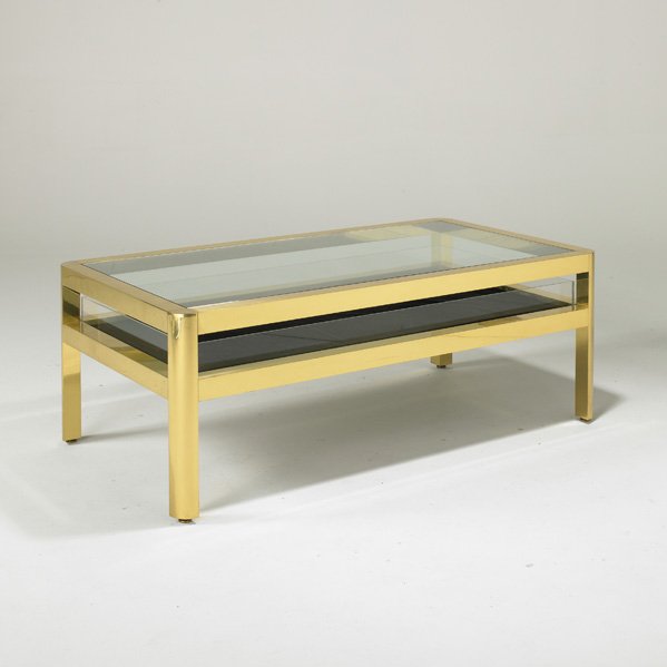KARL SPRINGER: Coffee table, USA, 1980s; Polished brass, glass, acrylic and felt; Unmarked; 19" x 52" x 28 1/2"