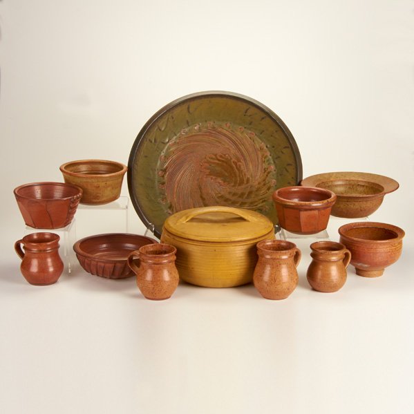 VAL CUSHING: Twelve pieces, USA, mid-1980s: seven bowls, four mugs, and one covered casserole dish; All marked, two dated; Largest: 17" dia.