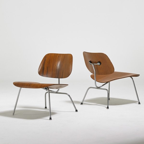 CHARLES & RAY EAMES; HERMAN MILLER: Pair of lounge chairs (LCM), Zeeland, MI, 1950s; Laminated walnut, chromed steel; One foil label, remnants of label to other; Each: 26" x 22" x 25"