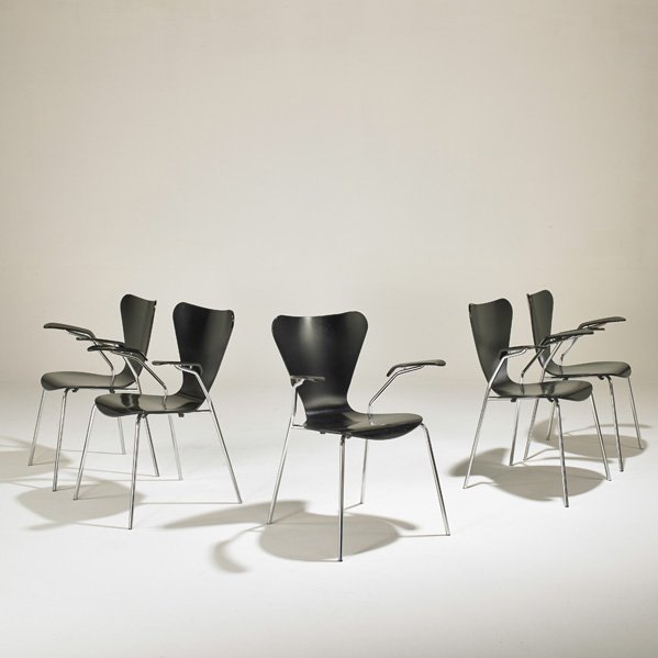 AFTER ARNE JACOBSEN: Five "Sevner" armchairs, 2000s; Ebonized wood, chromed steel; One with "Made in Italy" label.; 32" x 24 1/2" x 20"