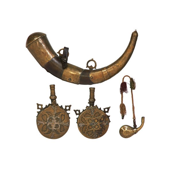 MIDDLE EASTERN POWDER FLASKS: Four, 19th/20th c.: two round in brass, horn with brass mountings and a primer with enamel decoration; Longest: 14"