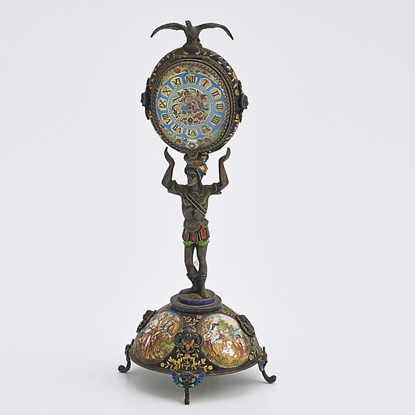 VIENNESE ENAMELED SILVER FIGURAL CLOCK: Oval KW KS clock supported by a blackamoor on dome pedestal and bracket feet, surmounted by an eagle with plique-Ã -jour enameled wings, mythological or romantic reserves on exterior and interior an