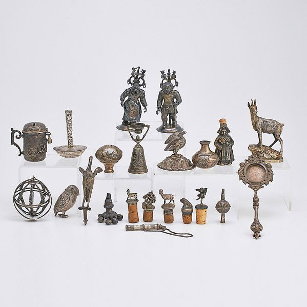 SILVER ACCESSORIES AND FRAGMENTS: Filigree silver orb-form cage; Two Austrian telescoping stands with threaded clutch-tops in the form of old women and young man; German double cup; Figural flask; Two American etched sterling knobs or