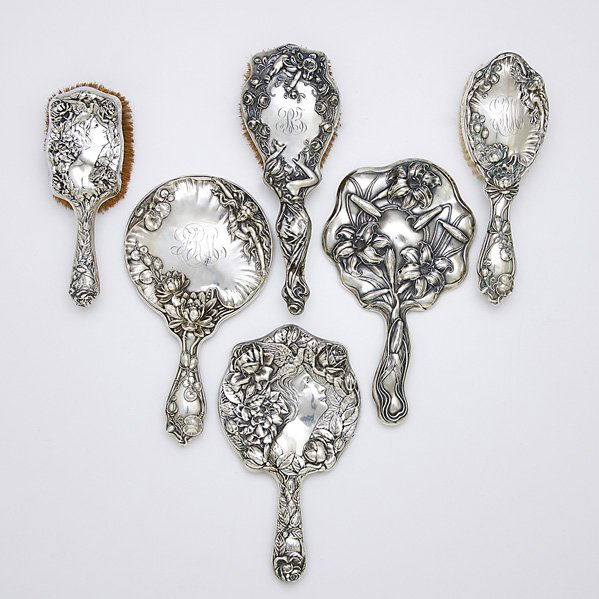 ART NOUVEAU STERLING BRUSHES AND MIRRORS: Six pieces: Unger Brothers hand mirror; Simon Brothers hand mirror and brush; F& B sterling hand mirror and brush; Brush by unidentified maker; Largest 10"
