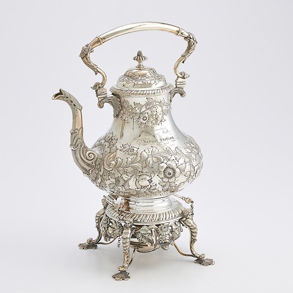 JONES BALL AND POOR COIN SILVER KETTLE ON STAND: Pear-shaped body chased with flowers and foliage, scroll and acanthus spot and handle, gadrooned stand with flowers and cherubs, ivory insulators, Boston 1852; Presented by Parker Iron Mills to Nathan