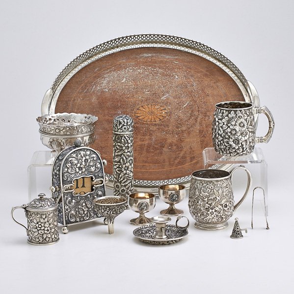 AMERICAN ORNAMENTAL SILVER, 19TH C.: Twelve pieces; Black Starr & Frost floral repousse sterling toothbrush case, 7"; J.E. Caldwell floral repousse sterling perpetual clock, 6 1/4"; Dominick & Haff sterling mounted marquetry serving tray