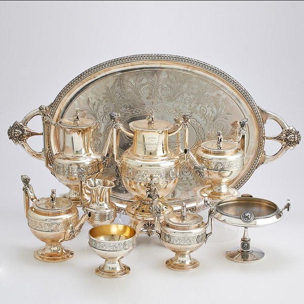 MEDALLION SILVER TEA /COFFEE SERVICE AND COMPOTE;: GORHAM; Eight Neoclassical coin silver elements #355, on silver-plated tray, with female bust handles, Greek sphinx finials, incised bands with relief medallions, cherub spigot handle, 1866: Hot water
