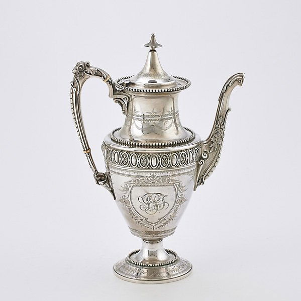 GORHAM FOR J.E. CALDWELL & CO. SILVER COFFEE POT: Coin silver, urn form with applied bead, raised egg and dart band, ram's head ornamental handle above split juncture, bright cut details, ivory insulators, ribbon monogram, ca. 1855; 12 1/2"; 34.17 OT