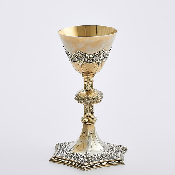 CONTINENTAL SILVER GILT CHALICE: Tapered bowl over hexagonal knop and incurved hexagonal foot with interlaced ribbons and incised decorations, 20th c.; Unrecognized maker mark H (goblet) N above 800; 9 5/8' x 6 3/8"; 18.45 OT