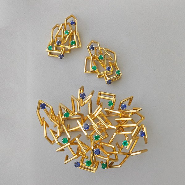 MODERNIST GEM SET 18K GOLD SUITE, JOSEPH WOLF: Impeccably constructed brooch and earrings set with bright blue sapphires and emeralds, ca. 1965. Brooch may be worn as pendant. 29.9 dwt. Brooch 2 1/2" x 1 3/4", earrings 1". Note: Jewelry by Joseph,