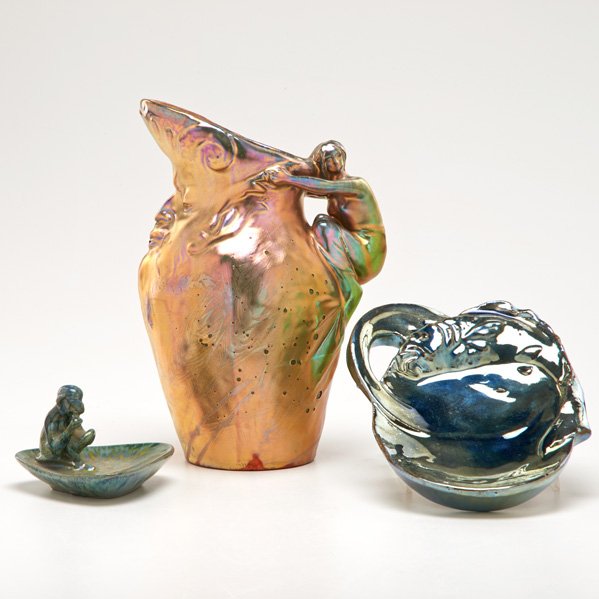 DELPHIN MASSIER; RAMBERVILLERS: Three lustered glaze pieces, France, ca. 1900; Delphin Massier pitcher with figural fawn handle; Rambervillers vide-poche decorated with carp designed by Charles Catteau and vide-poche decorated with