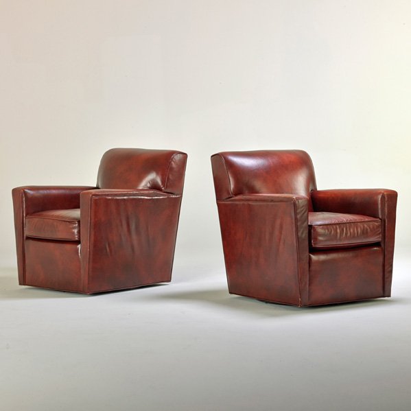 STICKLEY BY EJ AUDI CRAFTSMAN LEATHER: Pair of swiveling club chairs, Manlius, NY, 2000s; Leather; Upholstery label; 33 1/2" x 32" x 34"