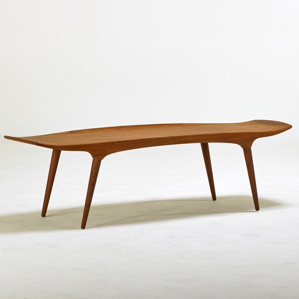 ARNE HOVMAND-OLSEN (Attr.); MOGENS KOLD: Sculpted teak coffee table, Denmark, 1960s; Manufacturer's label; 18" x 64" x 21"