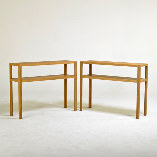 AFTER JEAN MICHEL FRANK; ECART INTERNATIONAL: Pair of console tables, retailed by Ralph Pucci, 1990s; Oiled oak; Unmarked; 33 1/2" x 43 1/2" x 12 1/2"