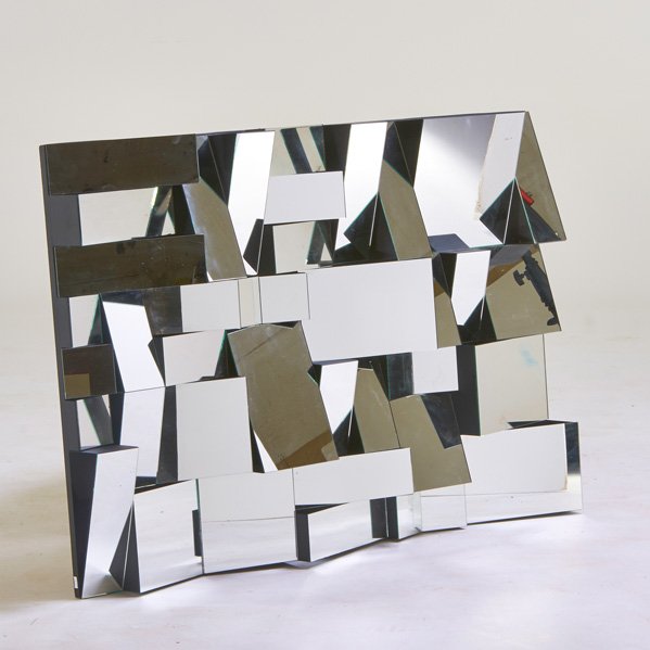 STYLE OF NEAL SMALL: Faceted mirror, USA, 2000s; Mirrored glass, painted wood and metal; 52" x 36 1/2" x 5"