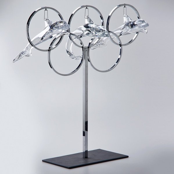 DAUM: “Dauphins Jouant.” (The Five Rings of the Olympics), in recognition of the 1968 Grenoble Olympic games, France, 1970; Chromed metal, glass; Dolphins signed, base marked Ltd. Edition 75 Pieces/No. 