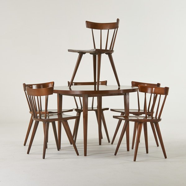PAUL McCOBB; WINCHEDON FURNITURE CO.: Planner Group dining set with table, and six side chairs, Winchendon, MA, 1950s; Stained and lacquered wood; Two chairs with foil labels; chairs: 31" x 19 3/4" x 19 1/2", table: 29" x 42" dia, leaf: 1