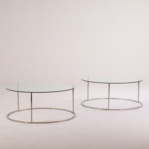 MILO BAUGHMAN; DESIGN INSTITUTE OF AMERICA: Pair of low tables, USA, 1980s; Chromed steel, glass; 17 1/2" x 41 1/2" dia